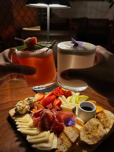 a plate of food on a table with a drink at Rango Hostel Boutique in Medellín