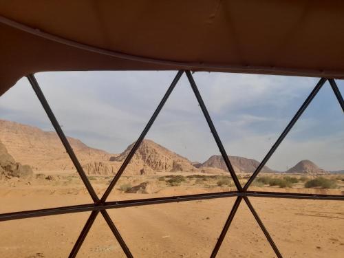a view from the inside of a tent in the desert at Marwan Rum Luxury Bubbles&Jeep Tour in Wadi Rum