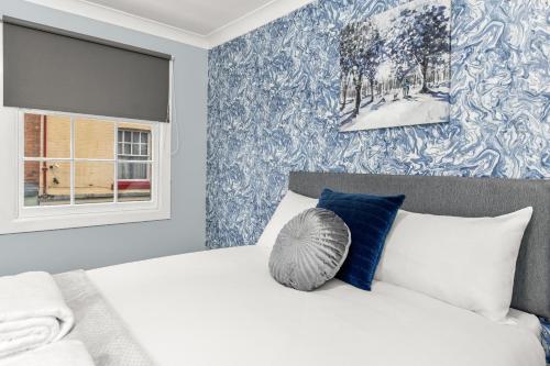 a bedroom with a white bed and a window at Town House Rooms in Boston