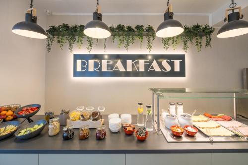 a restaurant with a breakfast counter with food at Baross City Hotel - Budapest in Budapest