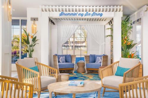 a porch with chairs and a table and a sign at Margaritaville Resort Cape Cod in Hyannis