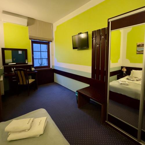 a hotel room with a bed and a mirror at EdMar in Malbork