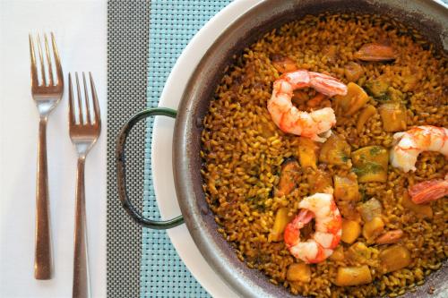 a bowl of food with shrimp and rice on a table at Port Azafata Valencia in Manises