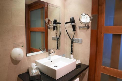 a bathroom with a sink and a phone on the wall at Port Azafata Valencia in Manises