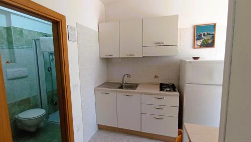a small bathroom with a sink and a toilet at Hotel Residence Villa Ascoli in Vieste