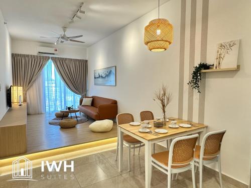 a living room with a table and chairs and a couch at ICC Ipoh Town Premium Suites By IWH Suites in Ipoh