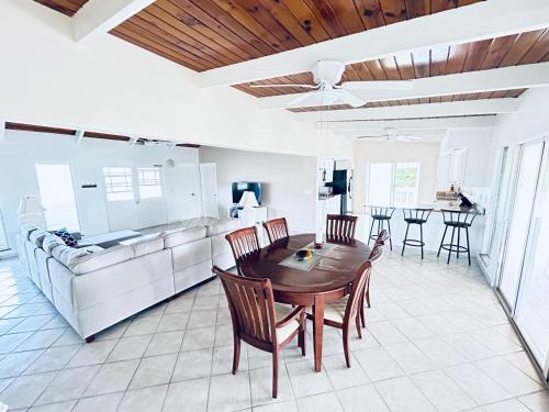 a kitchen and dining room with a table and chairs at Flamingo House - Turks & Caicos in Turtle Cove