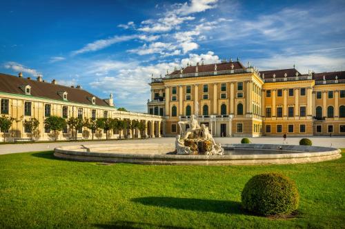 a large building with a fountain in front of it at lyf Schönbrunn Vienna in Vienna