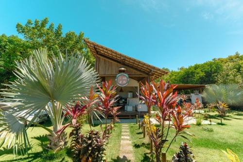 a house with a bunch of plants in front of it at Bons Ventos Camping e Glamping in Barra Grande