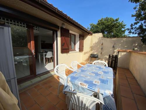 un patio avec une table et des chaises sur un balcon dans l'établissement Appartement duplex - 2701, à Soulac-sur-Mer