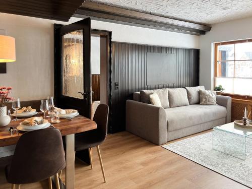 a living room with a couch and a table at Schwarzwald Residenz - Villa Hubertus in Feldberg