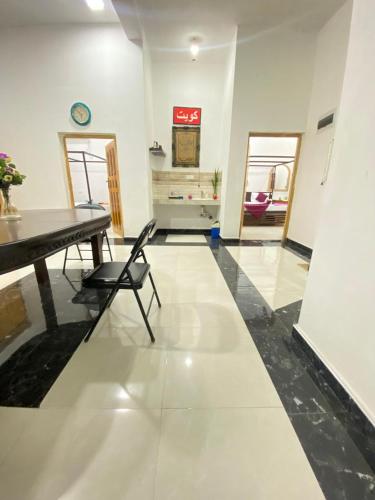a living room with a table and chairs and a counter at Arugambay Mailakska Green Villa in Arugam Bay