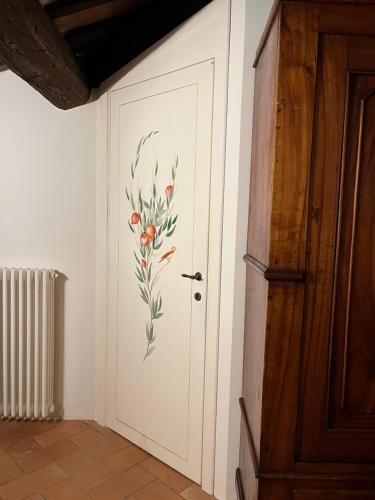 a door with a flower painted on it in a room at La Melagrana in Brisighella