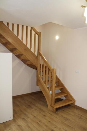 a staircase in a room with white walls and wooden floors at Kwatera agroturystyczna Przywóz in Przywóz