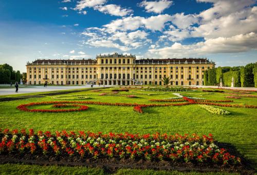 a large building with flowers in front of it at lyf Schönbrunn Vienna in Vienna