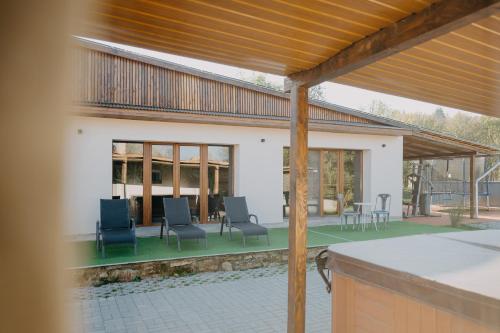 a pavilion with chairs and a table on a patio at Natura vendégház in Abaújvár