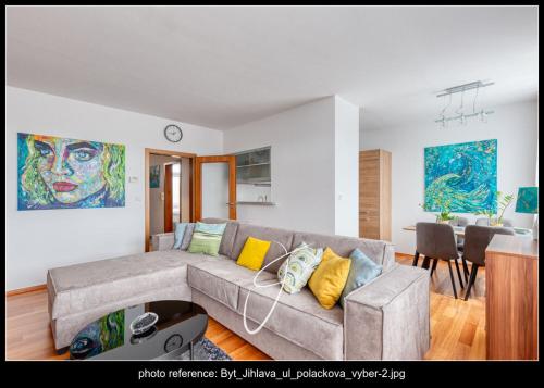 a living room with a couch and a dining room at Apartmán Poláčkova in Jihlava