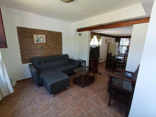 a living room with a couch and a table at Alojamiento Esparta in Villa Carlos Paz