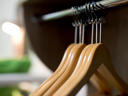a group of wooden hangers hanging from a rack at YHA Swanage in Swanage