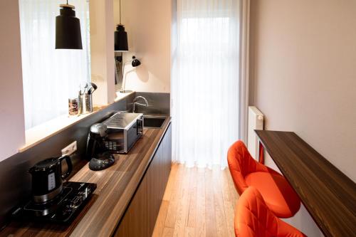 a kitchen with a counter with a coffee machine on it at BoardingWorld Heidelberg in Heidelberg