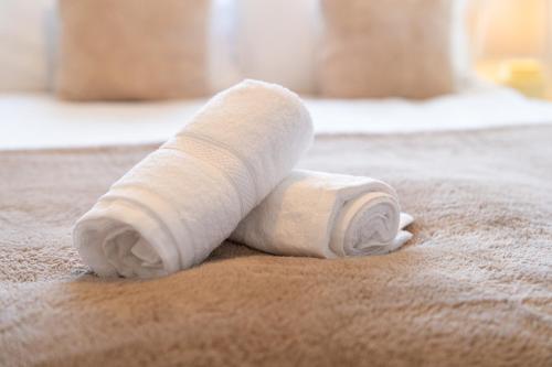 a roll of toilet paper sitting on a bed at Charming & Spacious City Centre House - Perfect for Family & Contractor - Sleeps 8 in Canterbury