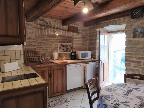 a kitchen with a sink and a counter top at Gîte Gîte Agnès 2/3 personnes in Laval-du-Tarn