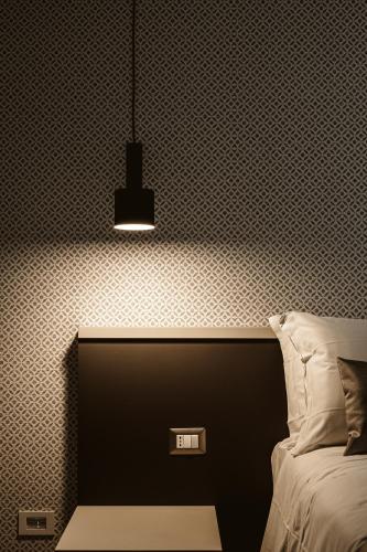 a bedroom with a bed and a black and white wall at B&B LUMAS in Rome