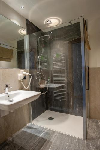 a bathroom with a sink and a shower at Dolomites Chalet Wolf 2 in Molveno