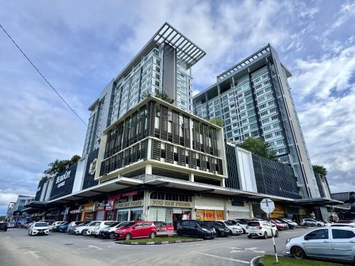 a large building with cars parked in a parking lot at MetroCity Square Condominium-3R2B-9 Pax in Kuching