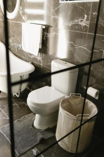 a bathroom with a toilet and a sink at Meraki Country Manor in Lanseria