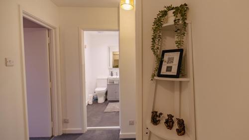 a hallway with a room with a toilet and a mirror at Cardiff City Centre - Luxury Apartments in Cardiff