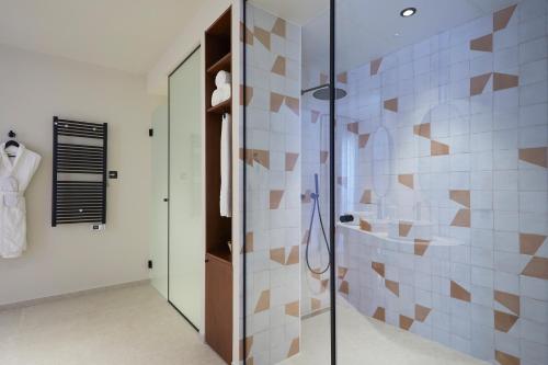 a bathroom with a shower with a glass door at 1881 Hotel Balneario Vichy Catalan in Caldes de Malavella