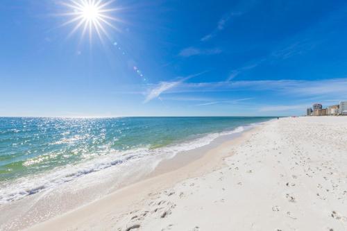 a sandy beach with the ocean in the background at Charming Condo Steps from the Beach & Lagoon! in Gulf Shores