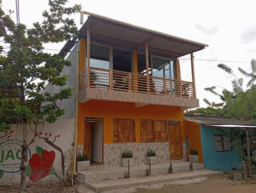 a house with a balcony on top of it at Casa Macondo RDM in San Onofre