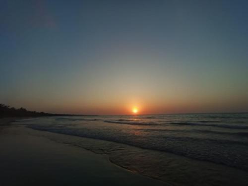 a sunset on a beach with the ocean at Casa Macondo RDM in San Onofre