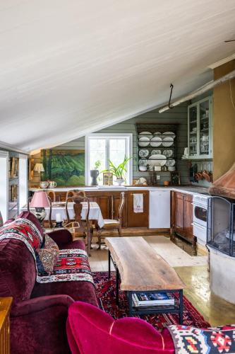 a living room with a couch and a table at Cozy guest house in the countryside in Håltebyn