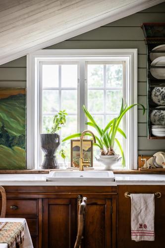 a kitchen with a sink and a window at Cozy guest house in the countryside in Håltebyn