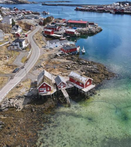 an aerial view of a small village in the water at Valen Cabins in Reine in Reine