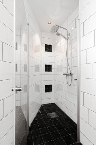 a bathroom with a shower with a glass door at The View - Tromsø City Center in Tromsø