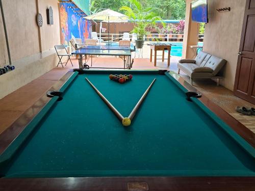 a pool table with a clock on top of it at Cool Waters Jungle Villas in Uvita