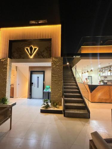 a lobby with a staircase in a building at Rixoss Tower Pyramids View in Cairo
