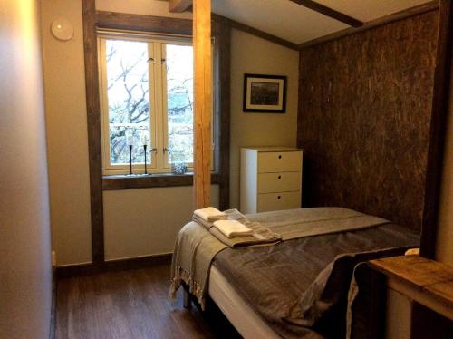 a bedroom with a bed and a window at Fredvang Seahouse, apartment A in Fredvang