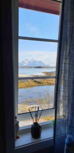 a window with a view of the water and mountains at Valberg High Quality Seaview Cabin in Valberg