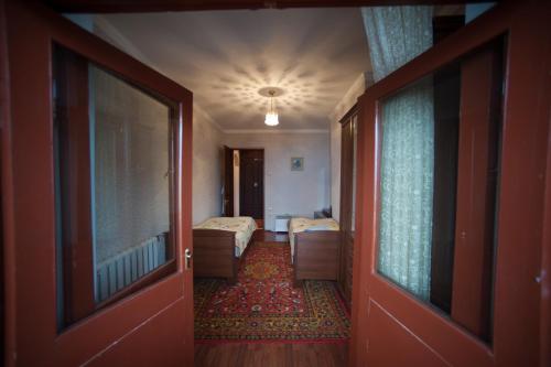 a hallway leading to a room with two beds at Baykalsky Pokoy Apartment in Listvyanka