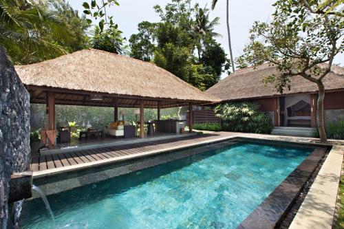 a pool with a pavilion and a villa at Kayumanis Ubud Private Villas & Spa in Ubud