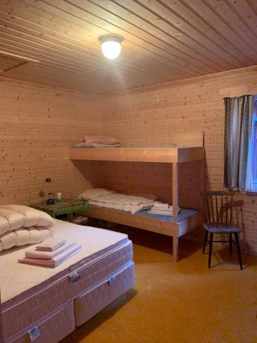 a room with two beds and a bunk bed at Northern Light Cabin Lofoten in Sennesvik
