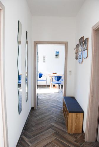 a hallway with a bench and a room with a table at Ferienwohnung Familie Schleicher in Nordheim vor der Rhön