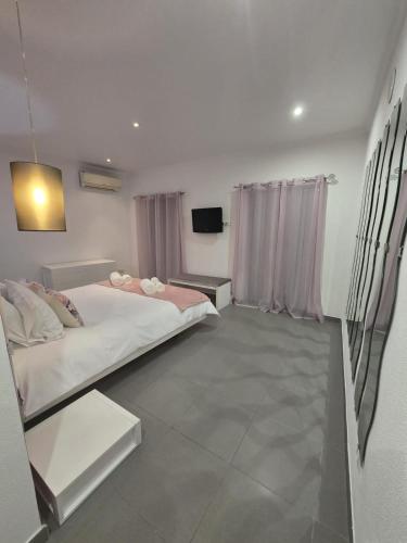 a bedroom with a bed and a tv in it at AL Manas Pereira in Castro Marim