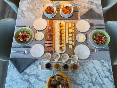 a table topped with plates and bowls of food at Villa Paladina in Foz do Arelho