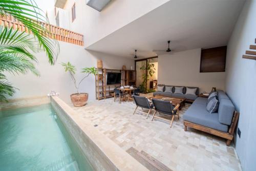 a house with a swimming pool and a living room at Casa Colibri en Punta Mita in Punta Mita